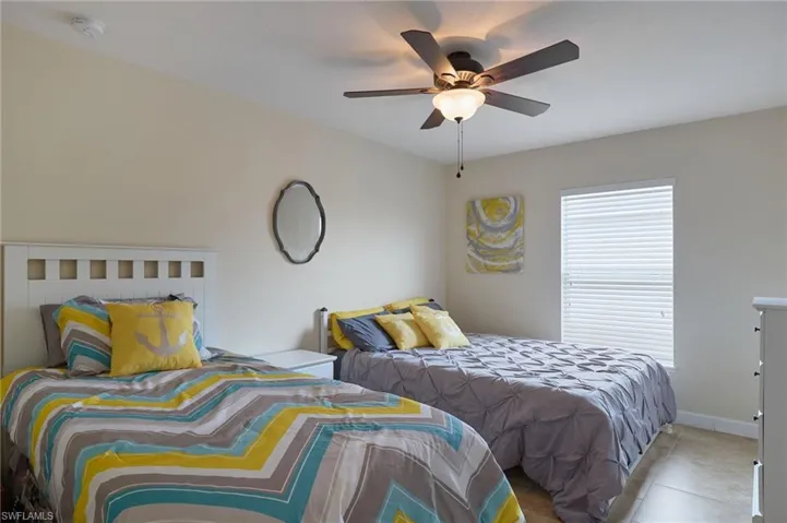Bedroom featuring ceiling fan and light tile patterned flooring