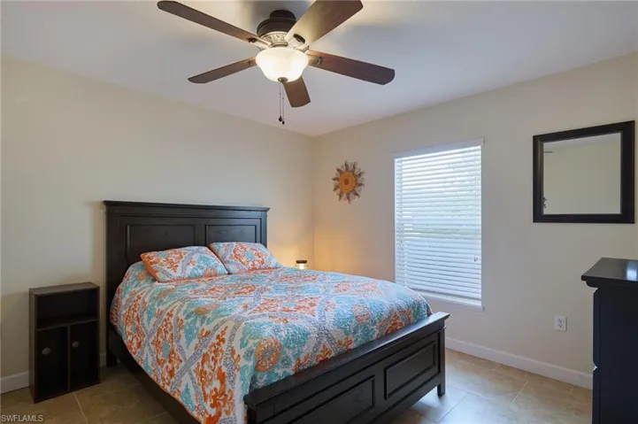Bedroom featuring ceiling fan and light tile patterned flooring