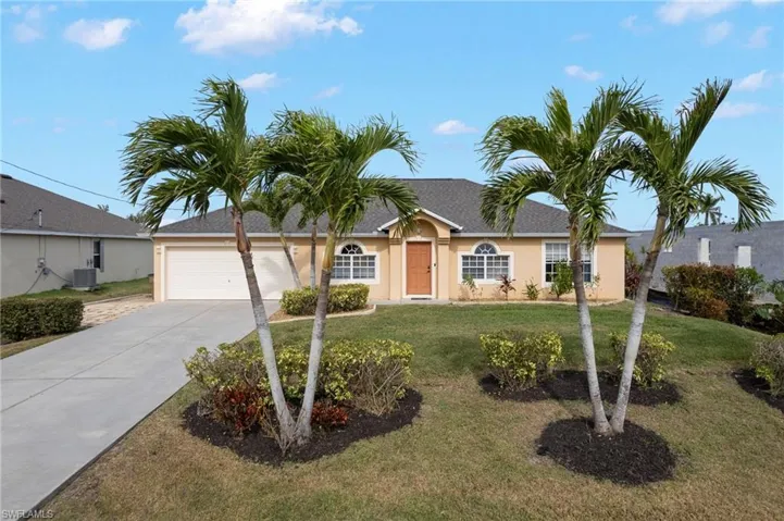 Ranch-style home with central AC unit, a garage, and a front yard