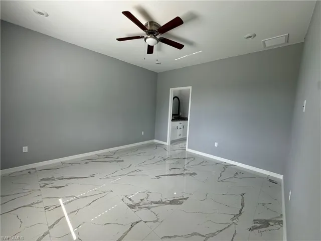 Tiled empty room with ceiling fan