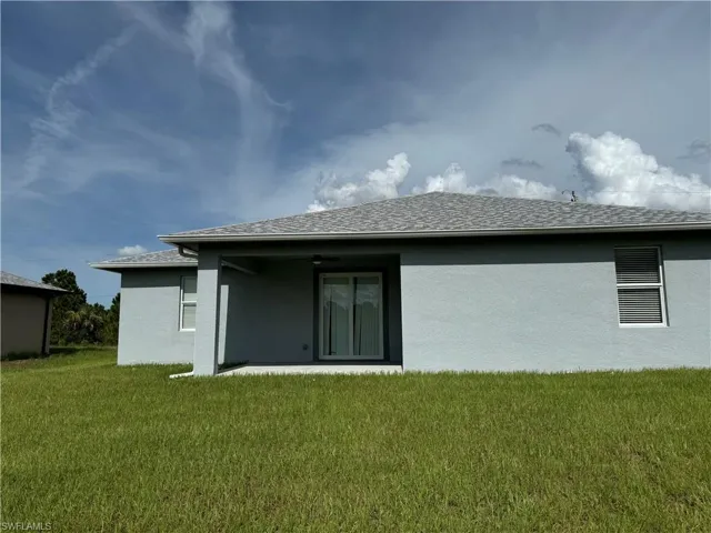 Rear view of property featuring a yard