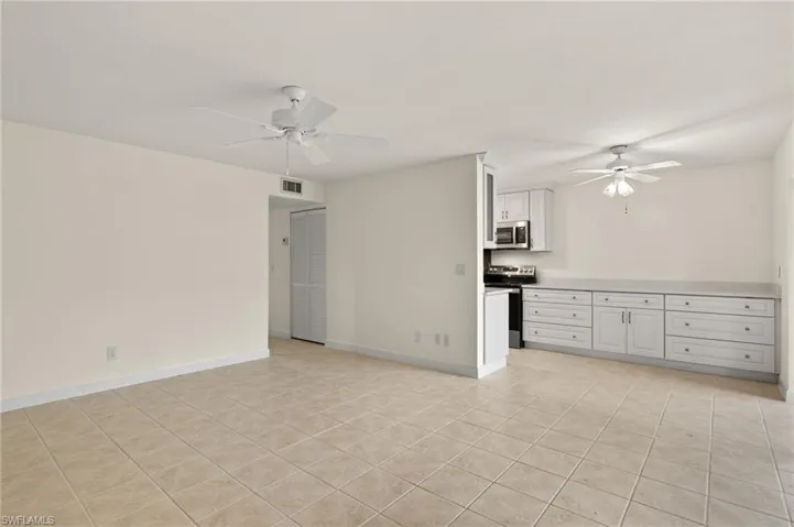 Spare room with light tile patterned flooring and ceiling fan