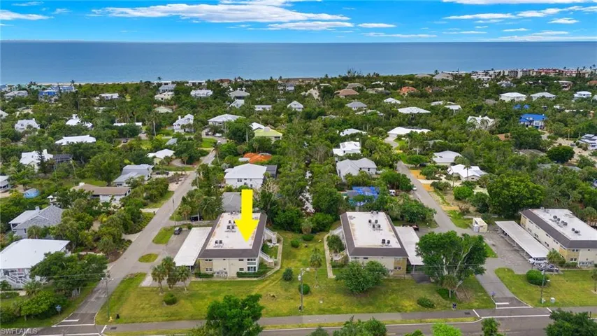 Birds eye view of property with a water view