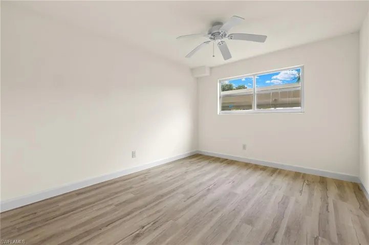 Spare room with ceiling fan and light hardwood / wood-style flooring