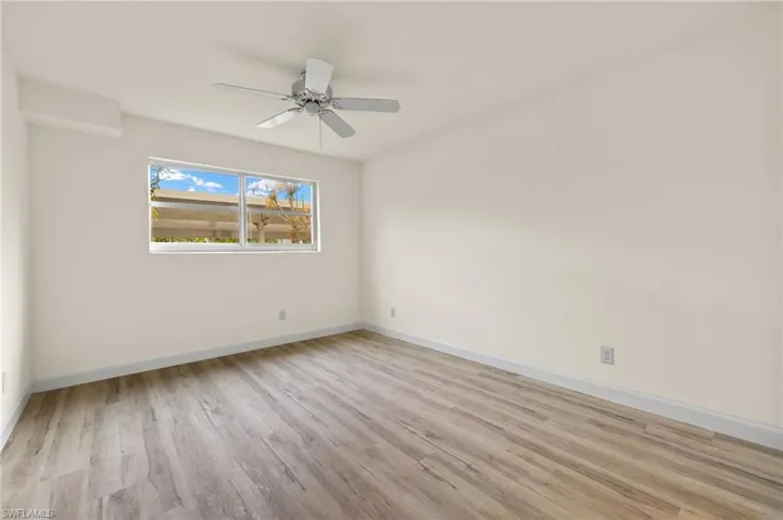 Spare room featuring ceiling fan and light wood-type flooring