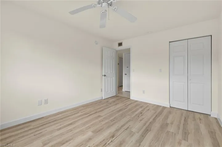 Unfurnished bedroom featuring ceiling fan, a closet, and light hardwood / wood-style flooring