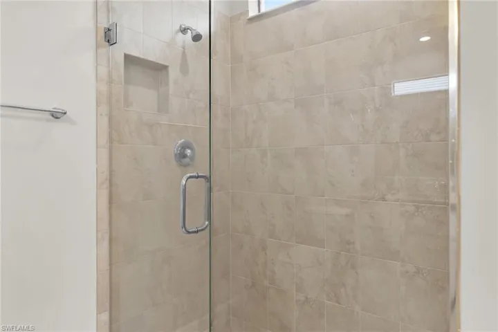 Full bath featuring a shower stall