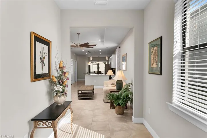 Hallway featuring recessed lighting and light tile patterned floors