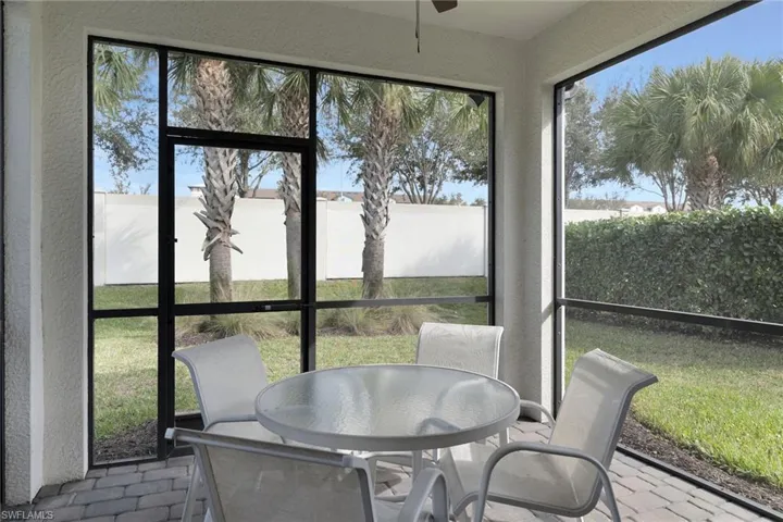 Sunroom / solarium featuring outdoor dining space and a ceiling fan