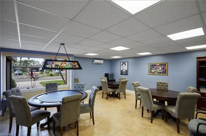 Tiled dining space featuring a paneled ceiling