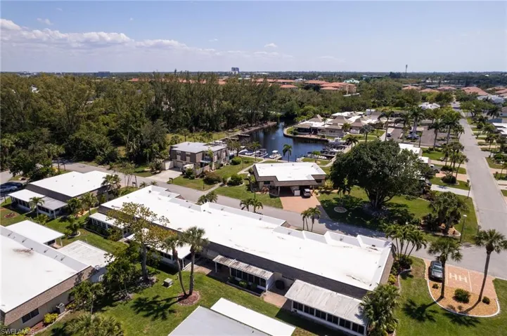 Aerial view of residential area featuring a nearby body of water