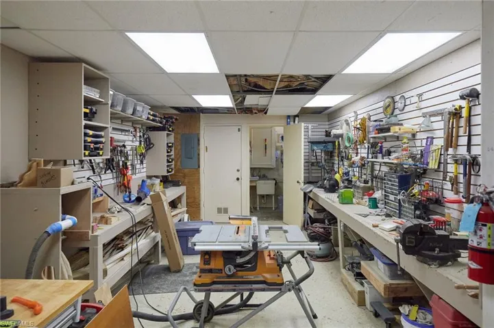 Miscellaneous room featuring electric panel and a drop ceiling