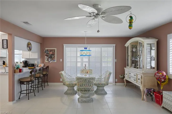 Dining space featuring a ceiling fan and light tile patterned floors