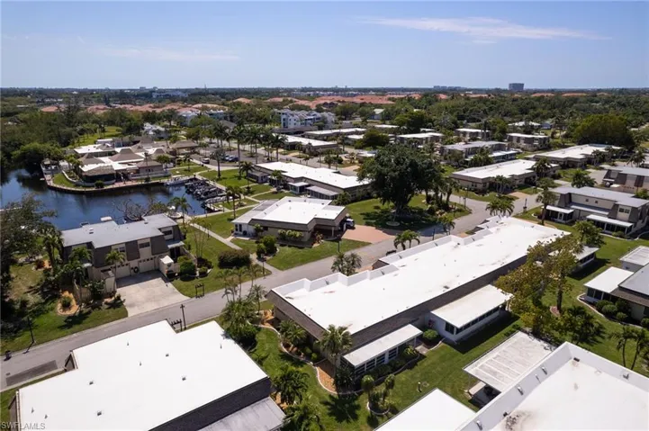 Aerial view of residential area featuring a nearby body of water