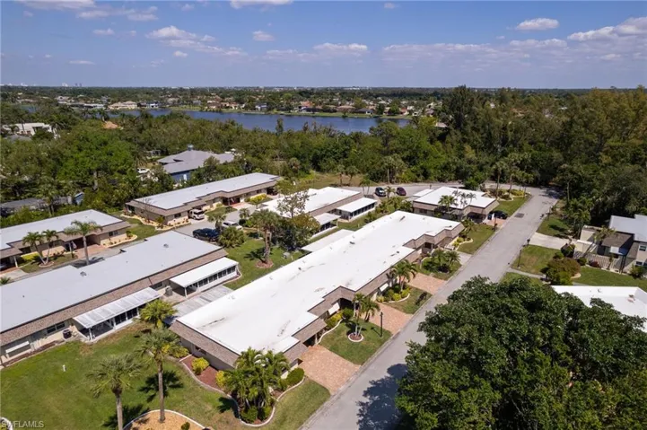 Aerial view of property's location with a tree filled landscape and nearby suburban area
