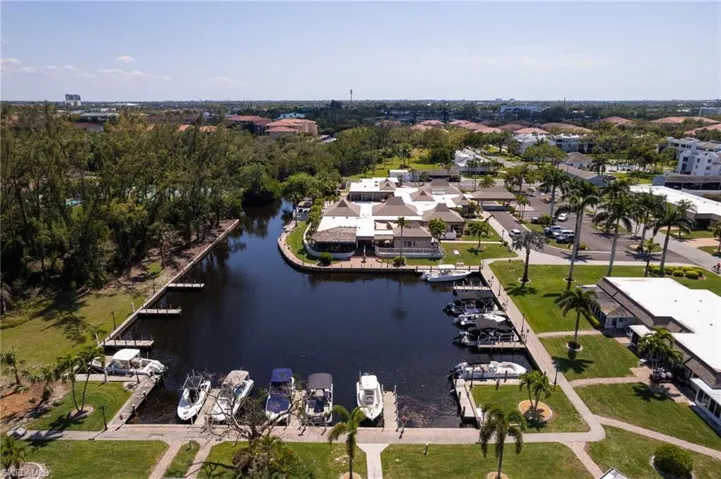 Aerial view of property and surrounding area with a large body of water and nearby suburban area