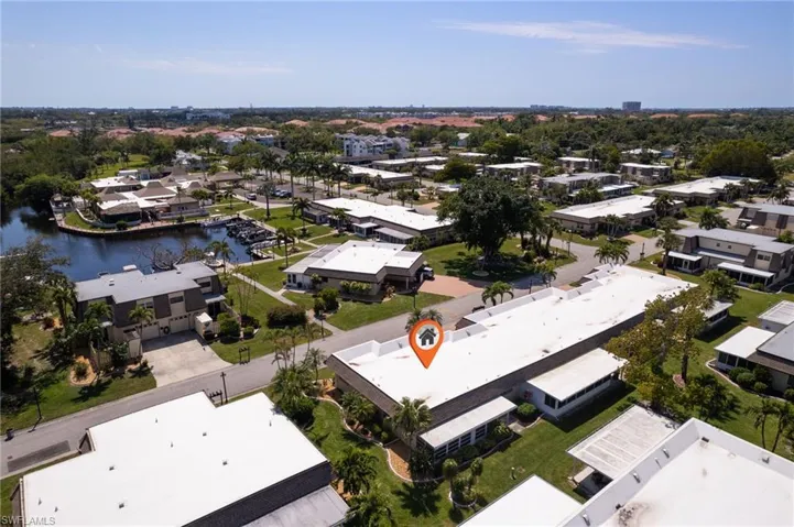 Aerial view of residential area featuring a nearby body of water