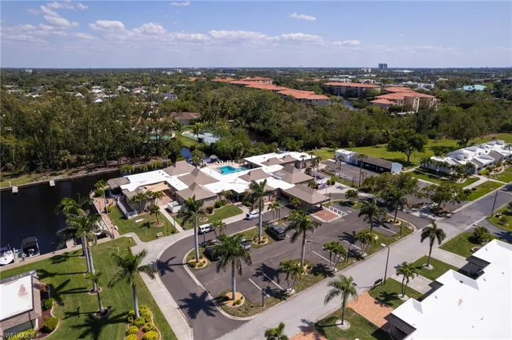 Aerial view of property and surrounding area featuring a nearby body of water