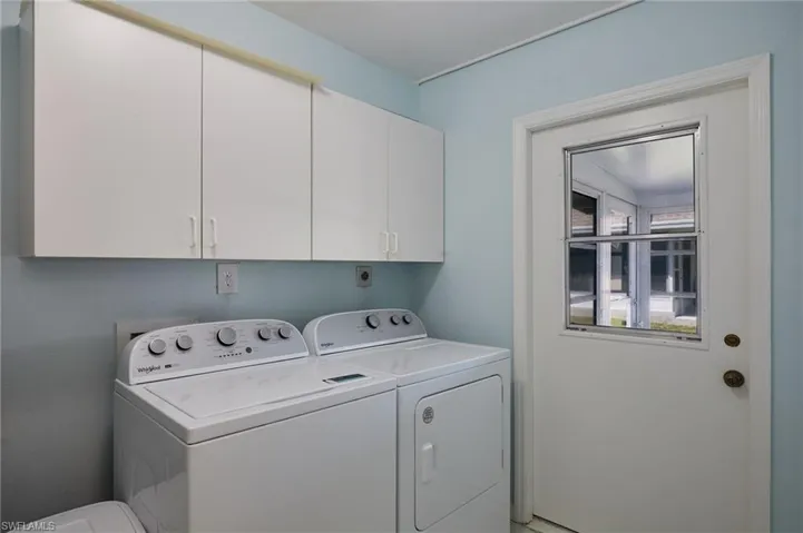Laundry area with cabinet space and washing machine and dryer
