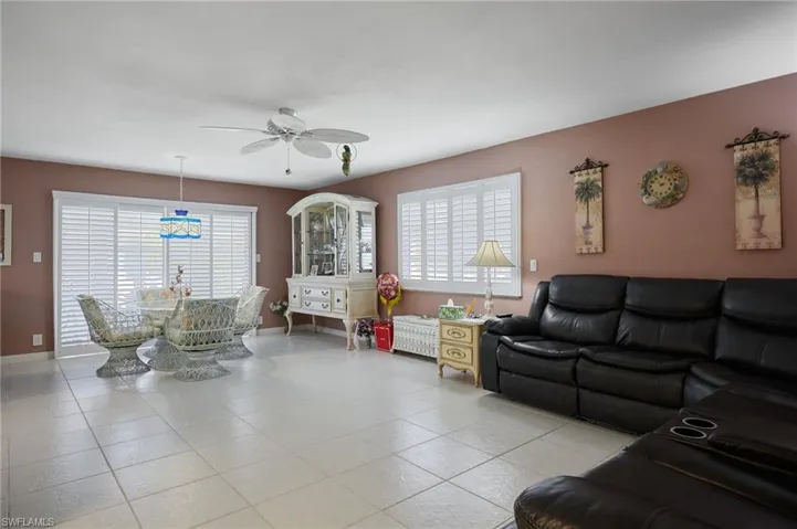 Living area with ceiling fan and light tile patterned floors