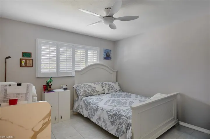 Tiled bedroom with ceiling fan
