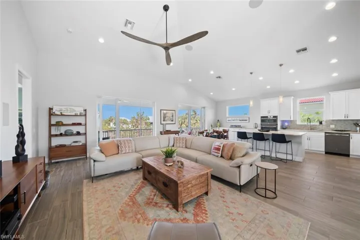Living room featuring plenty of natural light, light hardwood / wood-style floors, sink, and ceiling fan