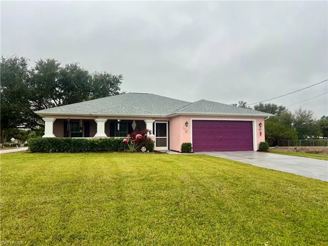 View of front of home featuring a garage and a front yard