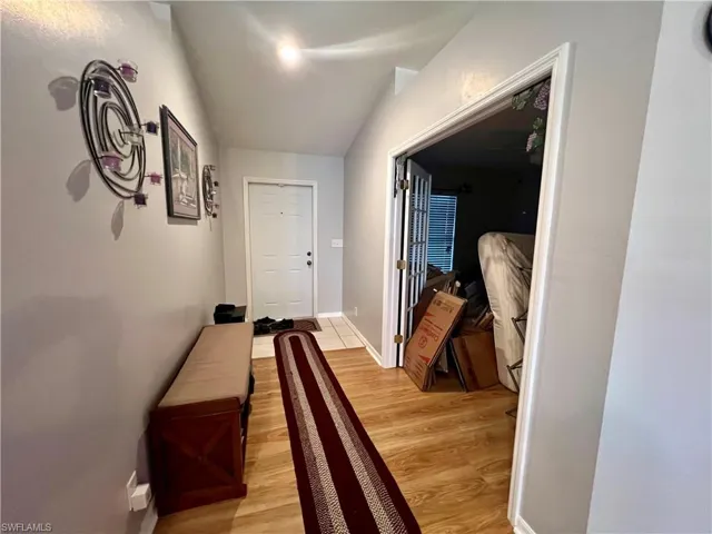 Entry foyer with French doors leading to the den.