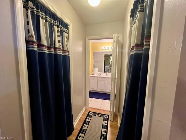 Entry to primary bathroom with two walk in closets