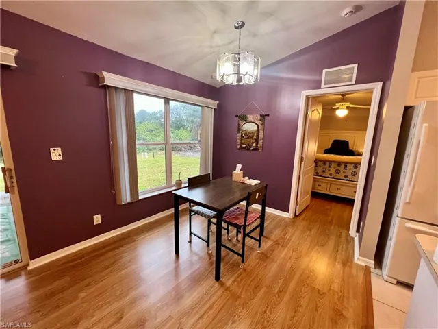 Dining space featuring light hardwood / wood-style floors and a chandelier