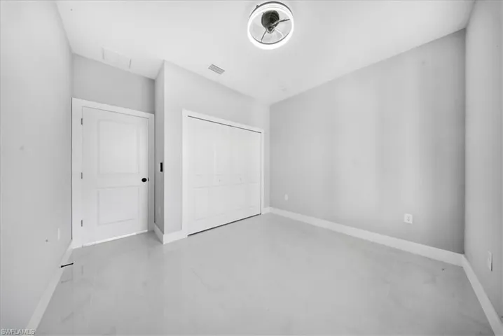 Unfurnished bedroom with baseboards and a closet