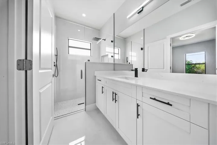 Bathroom featuring vanity, a shower stall, and recessed lighting