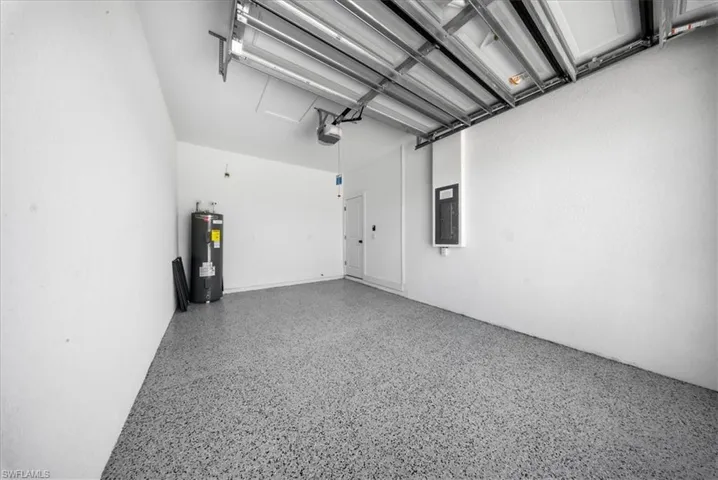 Garage with water heater and electric panel