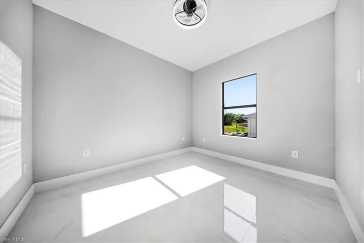 Empty room featuring baseboards