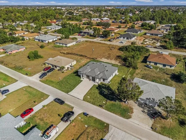 Aerial view of property and surrounding area with nearby suburban area