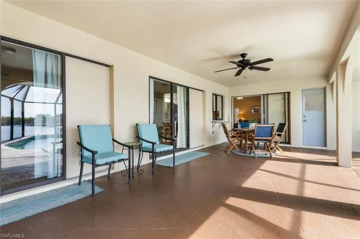 Large under truss seating area with three sliders into the house
