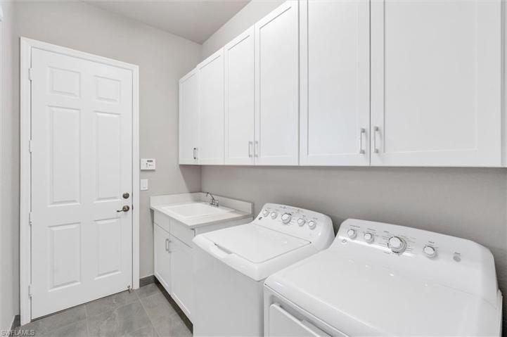 Window, custome Cabinets, laundry sink  with cabinet and  Quartz