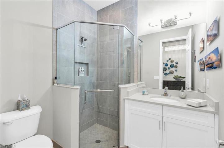 1ST  full bathroom, tiled to ceiling.