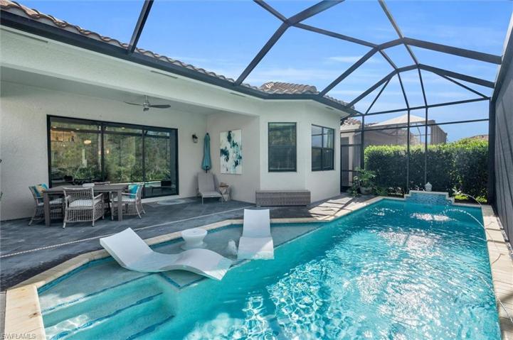 Custom heated salt water lap pool with cascading waterfall, bubbler on sun shelf with Ledge Loungers and 3 cascading water spouts