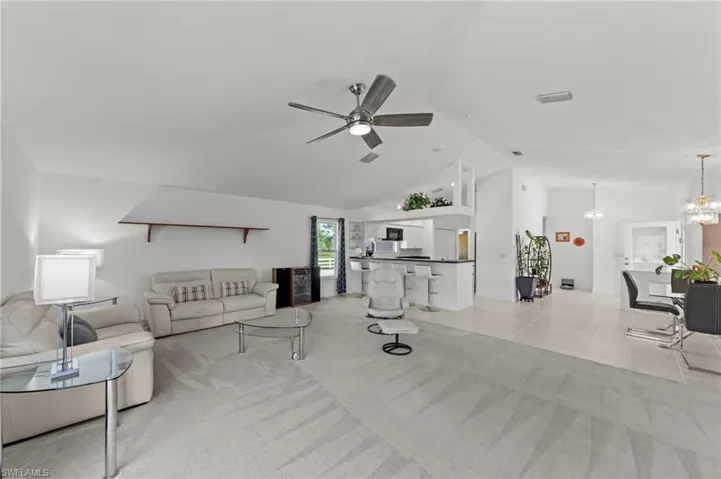 Vaulted ceilings complementing an open-concept living area with a ceiling fan