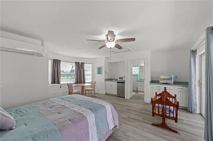 Open concept room featuring wood-finish flooring and a ceiling fan