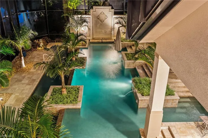 View of pool featuring a lanai and pool water feature