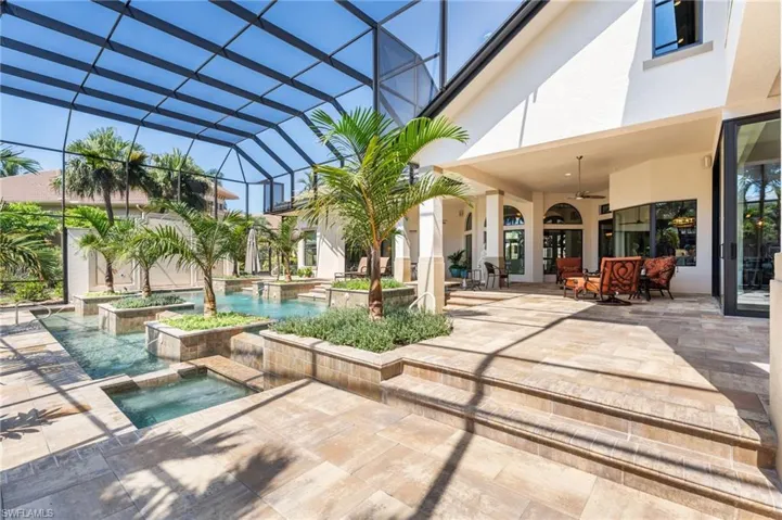 View of pool featuring a lanai, an in ground hot tub, a patio, and ceiling fan