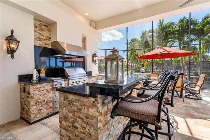View of patio / terrace with area for grilling, a grill, and a bar