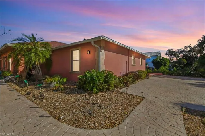 Property exterior at dusk featuring stucco siding