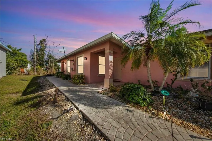 Property exterior at dusk featuring stucco siding