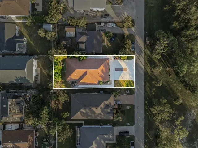 Aerial perspective of suburban area featuring property boundaries highlighted