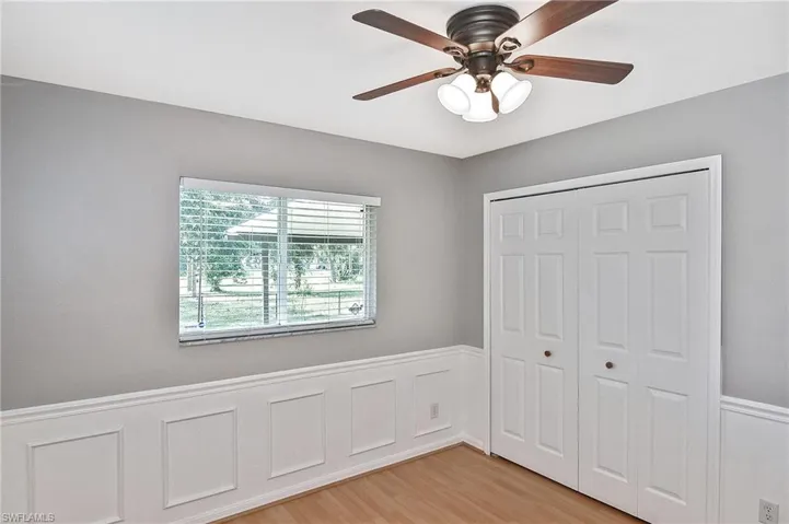 Unfurnished bedroom with ceiling fan, a closet, and light hardwood / wood-style floors