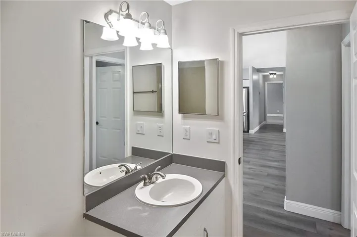 Bathroom featuring hardwood / wood-style flooring and vanity