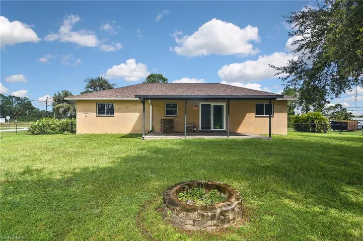 Back of house featuring a patio area and a yard